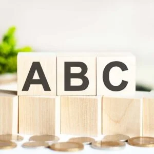 wooden-letter-blocks-with-coins-in-front
