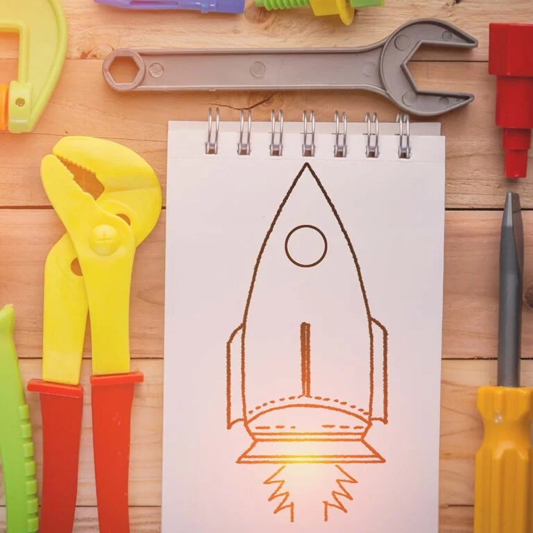 toy-tools-around-a-pencil-drwaing-of-a-rocket